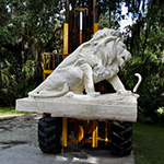 Statue of lion and snake being lifted